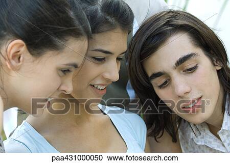 Group of young friends, looking down View Large Photo Image Stock Image - Group of young friends, looking down. Fotosearch