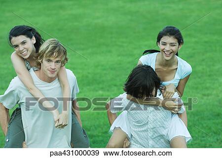 Group of young friends, riding piggyback View Large Photo Image Stock Photo - Group of young friends, riding piggyback. Fotosearch