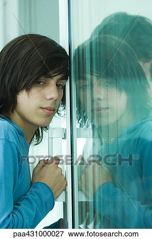 Teen boy opening sliding glass door View Large Photo Image Stock Photo - Teen boy opening sliding glass door. Fotosearch