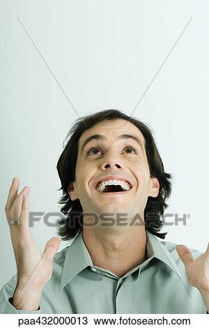 Stock Image - Man, head back and mouth wide open, holding up hands, head and shoulders, portrait. Fotosearch