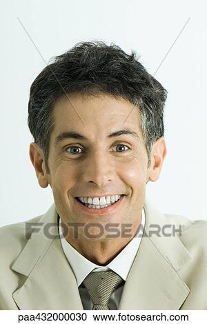 Man looking at camera with toothy smile, head and shoulders, portrait View Large Photo Image Stock Image - Man looking at camera with toothy smile, head and shoulders, portrait. Fotosearch