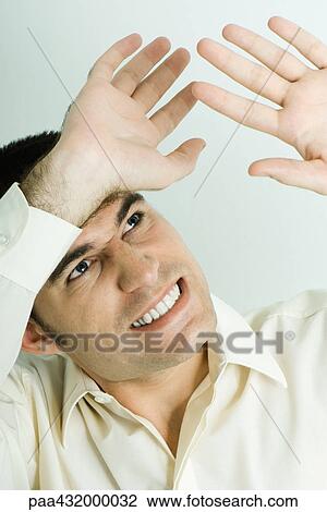 Man looking up, holding up hands protectively, head and shoulders, portrait View Large Photo Image Stock Image - Man looking up, holding up hands protectively, head and shoulders, portrait. Fotosearch