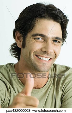 Man smiling at camera, giving thumbs up signal, head and shoulders, portrait View Large Photo Image Stock Photo - Man smiling at camera, giving thumbs up signal, head and shoulders, portrait. Fotosearch