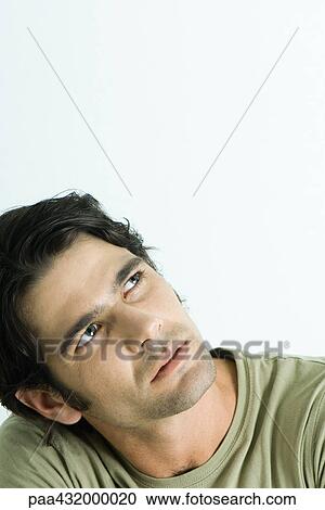 Man tilting head and looking up, head and shoulders, portrait View Large Photo Image Stock Image - Man tilting head and looking up, head and shoulders, portrait. Fotosearch