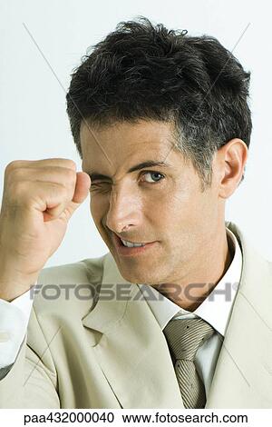 Man winking and making fist, head and shoulders, portrait View Large Photo Image Stock Image - Man winking and making fist, head and shoulders, portrait. Fotosearch