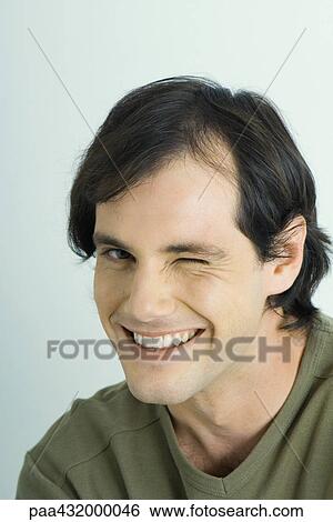 Man winking at camera, head and shoulders, portrait View Large Photo Image Stock Photograph - Man winking at camera, head and shoulders, portrait. Fotosearch