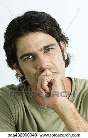 Man with fist in front of mouth, head and shoulders, portrait View Large Photo Image Stock Photo - Man with fist in front of mouth, head and shoulders, portrait. Fotosearch