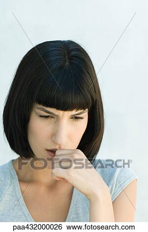 Woman biting thumb and looking down, head and shoulders, portrait View Large Photo Image Stock Photograph - Woman biting thumb and looking down, head and shoulders, portrait. Fotosearch