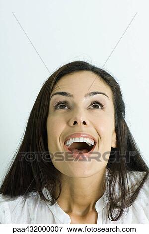 Woman looking up with mouth wide open, head and shoulders, portrait View Large Photo Image Stock Photo - Woman looking up with mouth wide open, head and shoulders, portrait. Fotosearch