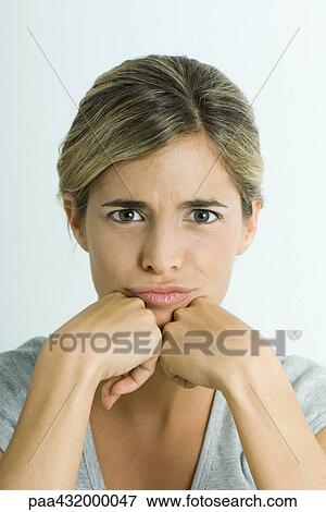 Stock Photo - Woman pouting, head and shoulders, portrait. Fotosearch