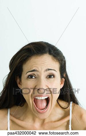 Woman screaming, looking at camera, head and shoulders, portrait View Large Photo Image Stock Image - Woman screaming, looking at camera, head and shoulders, portrait. Fotosearch