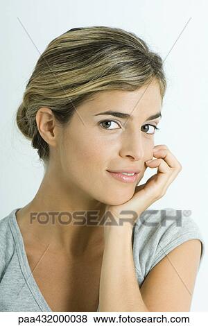 Woman smiling at camera, hand under chin, head and shoulders, portrait View Large Photo Image Stock Photo - Woman smiling at camera, hand under chin, head and shoulders, portrait. Fotosearch