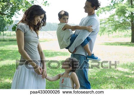 Family outdoors on a grassy lawn on a sunny day View Large Photo Image Stock Photograph - Family outdoors on a grassy lawn on a sunny day. Fotosearch