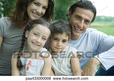 Family outdoors, smiling at camera, portrait View Large Photo Image Stock Photo - Family outdoors, smiling at camera, portrait. Fotosearch