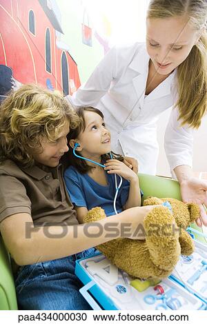 Boy and girl playing doctor, nurse looking over their shoulders View Large Photo Image Stock Image - Boy and girl playing doctor, nurse looking over their shoulders. Fotosearch