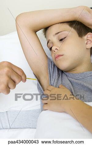 Boy raising arm, having temperature taken View Large Photo Image Stock Image - Boy raising arm, having temperature taken. Fotosearch