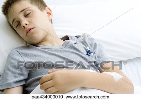 Boy sleeping in hospital bed, IV in arm View Large Photo Image Stock Image - Boy sleeping in hospital bed, IV in arm. Fotosearch