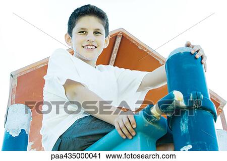 Boy on playground equipment, smiling at camera View Large Photo Image Stock Image - Boy on playground equipment, smiling at camera. Fotosearch