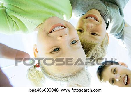 Children huddling, low angle view View Large Photo Image Stock Photo - Children huddling, low angle view. Fotosearch