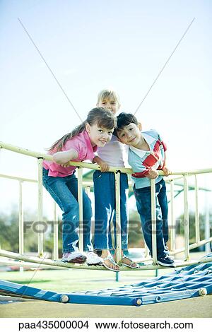 Children on playground equipment, smiling at camera View Large Photo Image Picture - Children on playground equipment, smiling at camera. Fotosearch