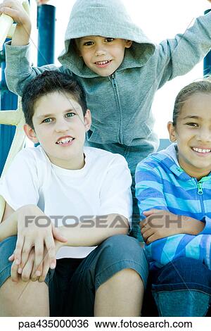 Children on playground equipment, smiling at camera View Large Photo Image Stock Photograph - Children on playground equipment, smiling at camera. Fotosearch