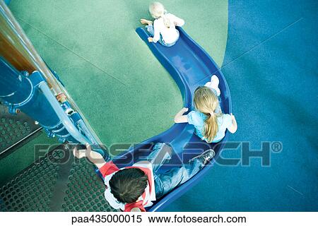 Children on playground slide, high angle view View Large Photo Image Stock Photography - Children on playground slide, high angle view. Fotosearch
