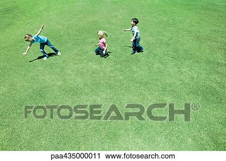 Children playing on grass, high angle view View Large Photo Image Stock Image - Children playing on grass, high angle view. Fotosearch