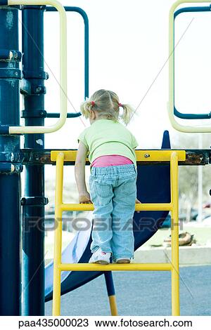 Girl climbing ladder on playground equipment View Large Photo Image Stock Image - Girl climbing ladder on playground equipment. Fotosearch