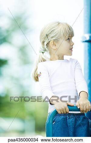 Picture - Girl on playground equipment, looking up. Fotosearch