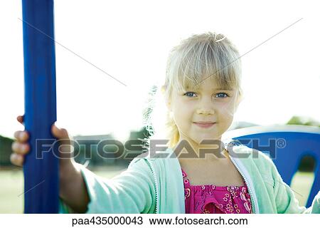 Girl on playground equipment, smiling at camera View Large Photo Image Stock Image - Girl on playground equipment, smiling at camera. Fotosearch