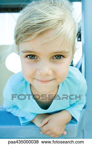 Girl on playground equipment, smiling at camera, portrait View Large Photo Image Stock Photo - Girl on playground equipment, smiling at camera, portrait. Fotosearch