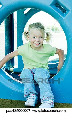 Girl sitting in playground equipment View Large Photo Image Stock Photo - Girl sitting in playground equipment. Fotosearch