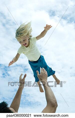 Man throwing little girl into the air, low angle view View Large Photo Image Stock Image - Man throwing little girl into the air, low angle view. Fotosearch