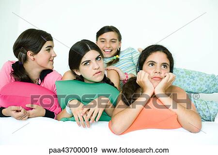 Four young female friends reclining with cushions and looking away View Large Photo Image Stock Photo - Four young female friends reclining with cushions and looking away. Fotosearch