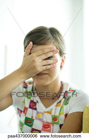 Teen girl covering face with hand, peeking through fingers View Large Photo Image Stock Photograph - Teen girl covering face with hand, peeking through fingers. Fotosearch