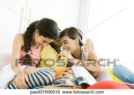 Three young female friends laughing View Large Photo Image Stock Photo - Three young female friends laughing. Fotosearch