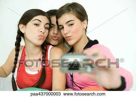 Three young female friends puckering as one takes photo with digital camera View Large Photo Image Stock Image - Three young female friends puckering as one takes photo with digital camera. Fotosearch