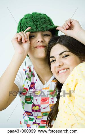 Stock Photo - Two young female friends, smiling at camera. Fotosearch