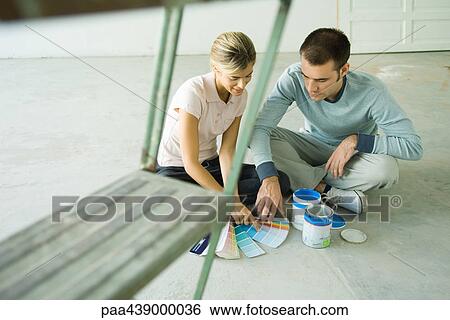 Couple looking at paint swatches View Large Photo Image Stock Photograph - Couple looking at paint swatches. Fotosearch