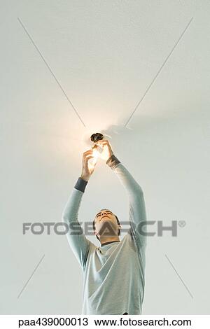Man changing lightbulb View Large Photo Image Stock Image - Man changing lightbulb. Fotosearch