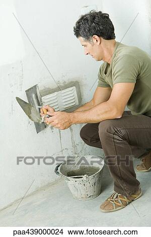 Man grouting around air vent View Large Photo Image Picture - Man grouting around air vent. Fotosearch