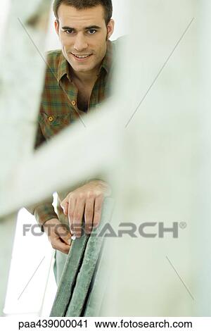 Man standing next to cement tiles, focus on background View Large Photo Image Stock Image - Man standing next to cement tiles, focus on background. Fotosearch