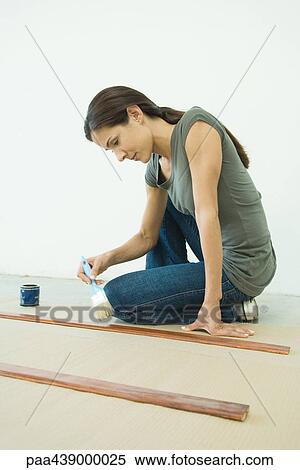 Woman applying varnish to pieces of wood View Large Photo Image Stock Photography - Woman applying varnish to pieces of wood. Fotosearch