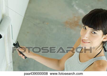 Woman painting with paint roller, high angle view View Large Photo Image Stock Photo - Woman painting with paint roller, high angle view. Fotosearch