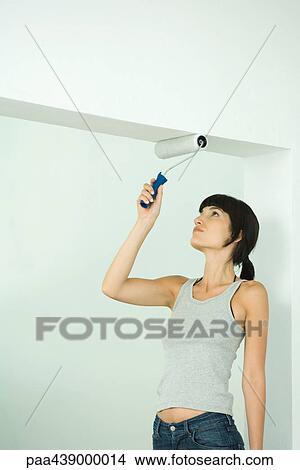 Woman painting with paint roller View Large Photo Image Picture - Woman painting with paint roller. Fotosearch