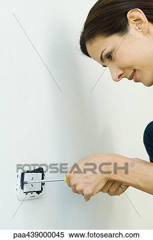 Woman removing lightswitch cover from wall View Large Photo Image Stock Photography - Woman removing lightswitch cover from wall. Fotosearch