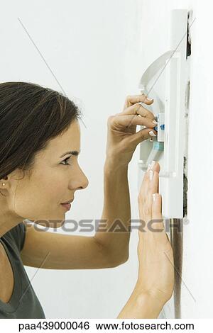 Woman replacing fuse in fusebox View Large Photo Image Stock Photograph - Woman replacing fuse in fusebox. Fotosearch