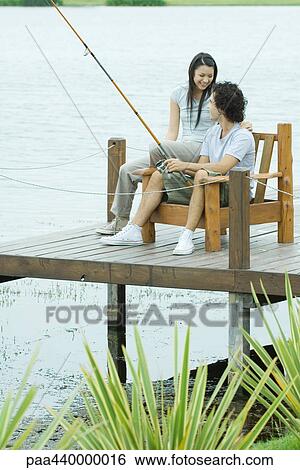 Couple fishing on pier View Large Photo Image Stock Photograph - Couple fishing on pier. Fotosearch