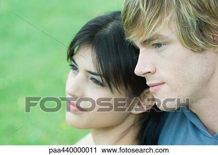 Young couple, looking away, close-up View Large Photo Image Stock Image - Young couple, looking away, close-up. Fotosearch
