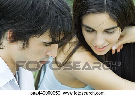 Young couple together, looking down View Large Photo Image Stock Image - Young couple together, looking down. Fotosearch